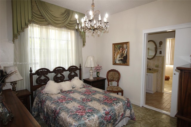 bedroom with a chandelier and ensuite bath