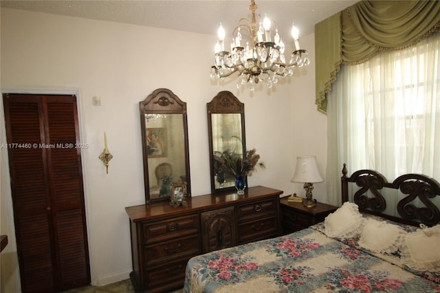 bedroom with an inviting chandelier and baseboards