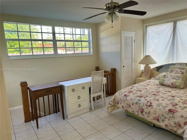 bedroom featuring a ceiling fan and light tile patterned flooring