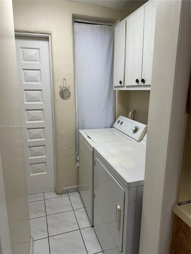 laundry room with independent washer and dryer and cabinet space