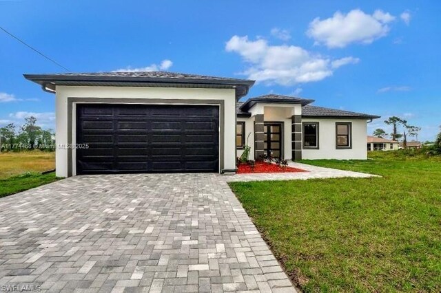 3114 39th St SW, Lehigh Acres, FL 33976 - prairie-style house with stucco siding, driveway, an attached garage, and a front yard