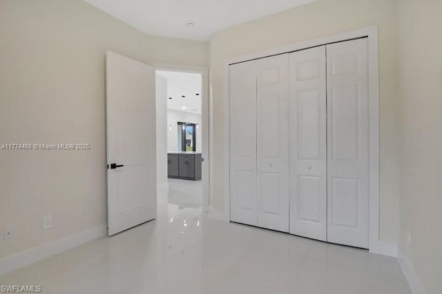 3114 39th St SW, Lehigh Acres, FL 33976 - unfurnished bedroom with a closet and baseboards