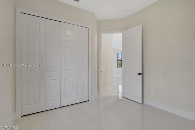 3114 39th St SW, Lehigh Acres, FL 33976 - unfurnished bedroom with a closet