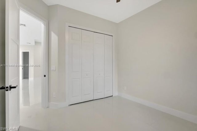 3114 39th St SW, Lehigh Acres, FL 33976 - unfurnished bedroom featuring a closet and baseboards