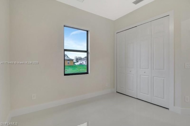 3114 39th St SW, Lehigh Acres, FL 33976 - unfurnished bedroom with baseboards and a closet