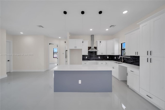 3114 39th St SW, Lehigh Acres, FL 33976 - kitchen with a sink, wall chimney exhaust hood, tasteful backsplash, a center island, and white cabinets