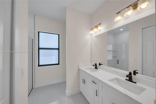 3114 39th St SW, Lehigh Acres, FL 33976 - bathroom with double vanity, a sink, a stall shower, and baseboards
