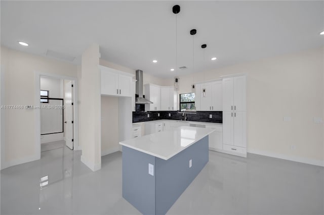 3114 39th St SW, Lehigh Acres, FL 33976 - kitchen featuring white cabinets, a center island, a sink, wall chimney range hood, and backsplash