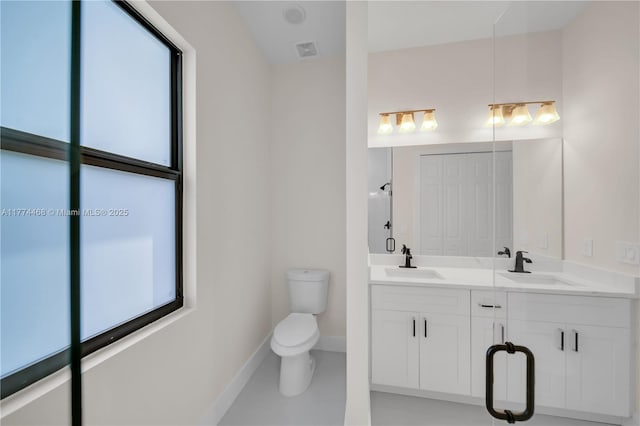 3114 39th St SW, Lehigh Acres, FL 33976 - bathroom featuring double vanity, visible vents, toilet, and a sink