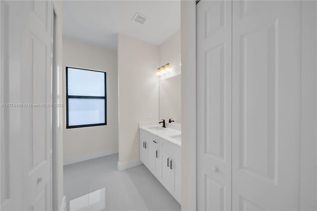 3114 39th St SW, Lehigh Acres, FL 33976 - full bath featuring a closet, visible vents, baseboards, double vanity, and a sink