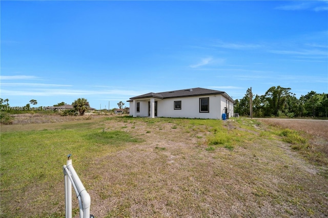 3114 39th St SW, Lehigh Acres, FL 33976 - back of house featuring stucco siding