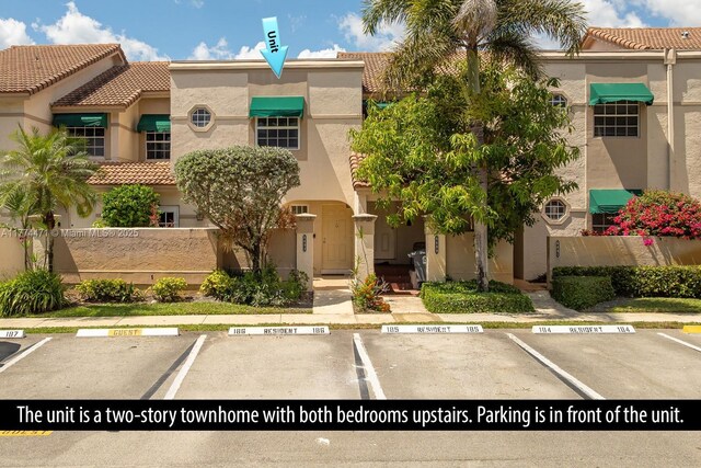 view of property featuring uncovered parking