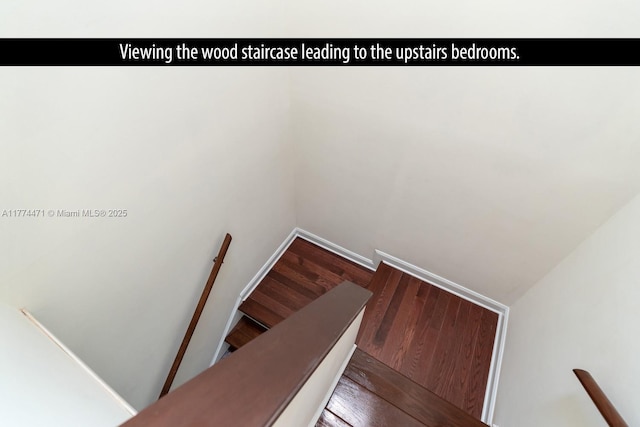 stairs with baseboards and wood finished floors