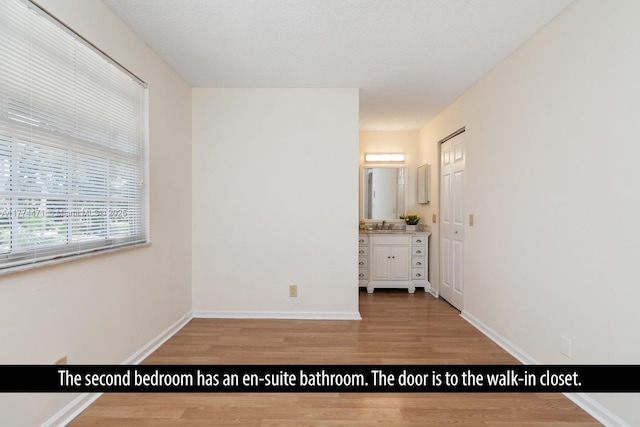 unfurnished bedroom featuring baseboards and light wood-style floors