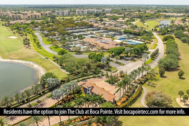 drone / aerial view featuring view of golf course and a water view