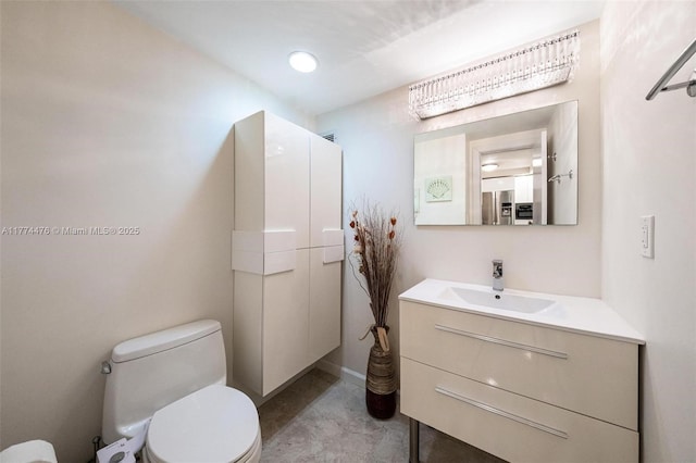 bathroom featuring toilet and vanity