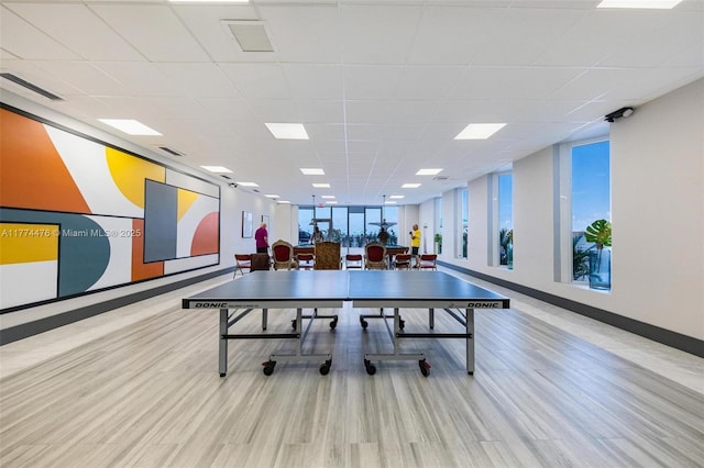 recreation room featuring wood finished floors, baseboards, visible vents, and a wealth of natural light