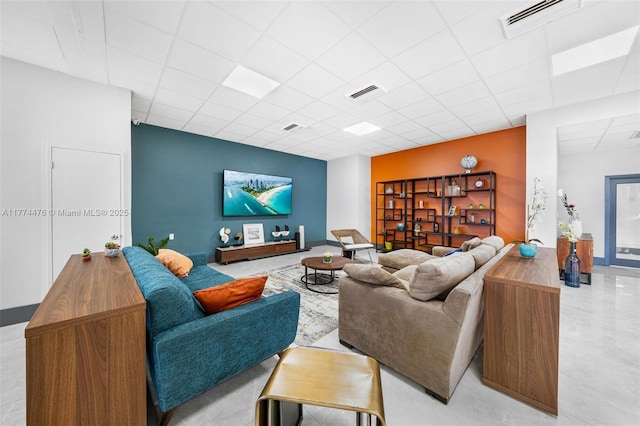 living room featuring a paneled ceiling and visible vents