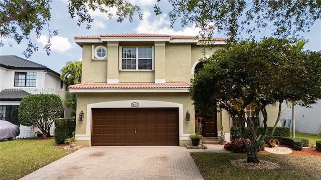 16473 SW 30th St, Miramar, FL 33027 - mediterranean / spanish home featuring an attached garage, stucco siding, and decorative driveway