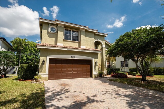 16473 SW 30th St, Miramar, FL 33027 - mediterranean / spanish-style house featuring stucco siding, an attached garage, a tiled roof, and decorative driveway