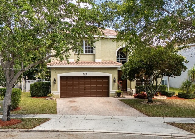 16473 SW 30th St, Miramar, FL 33027 - view of front of house featuring a tiled roof, decorative driveway, stucco siding, and an attached garage