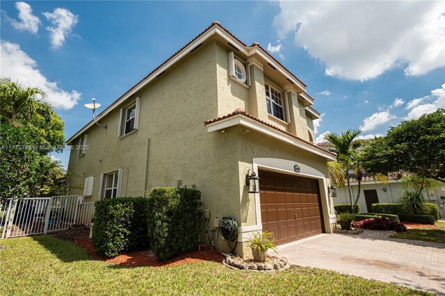 16473 SW 30th St, Miramar, FL 33027 - view of side of home featuring a garage, stucco siding, driveway, and a tile roof