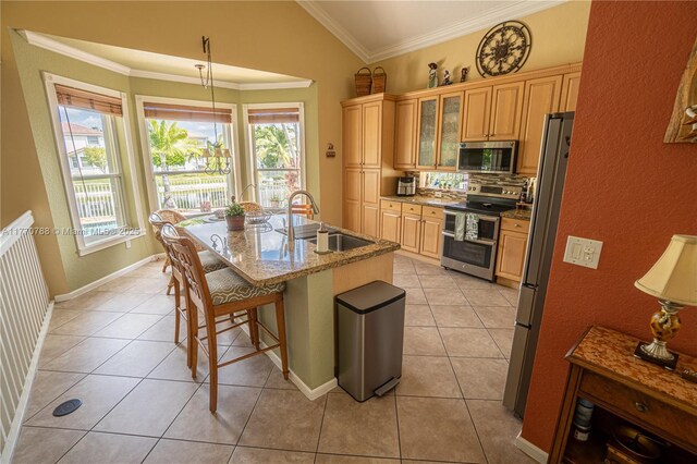16473 SW 30th St, Miramar, FL 33027 - kitchen with stainless steel appliances, ornamental molding, a kitchen bar, light tile patterned floors, and a textured wall