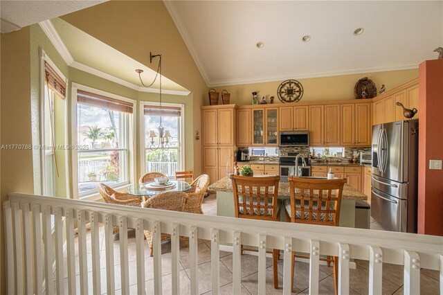 16473 SW 30th St, Miramar, FL 33027 - kitchen with stainless steel appliances, decorative backsplash, an island with sink, vaulted ceiling, and light tile patterned flooring