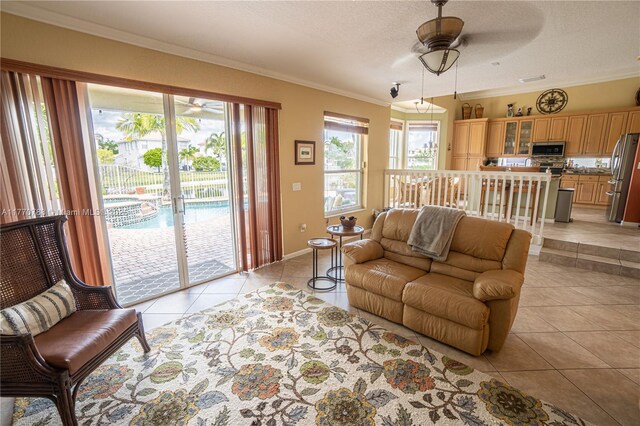 16473 SW 30th St, Miramar, FL 33027 - living area featuring light tile patterned flooring, a ceiling fan, ornamental molding, and a textured ceiling