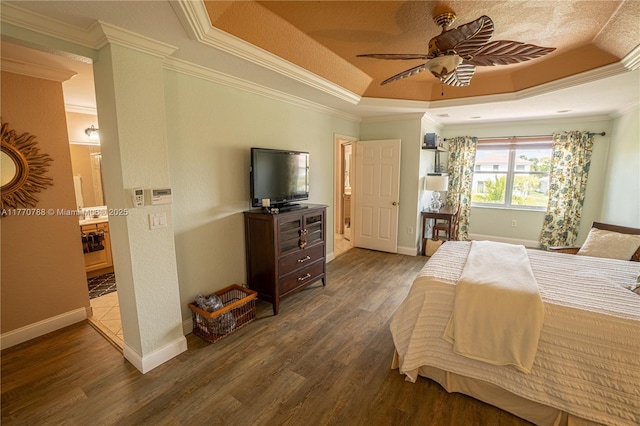 16473 SW 30th St, Miramar, FL 33027 - bedroom featuring a raised ceiling, wood finished floors, crown molding, connected bathroom, and a ceiling fan