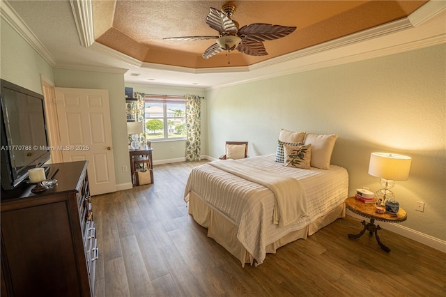 16473 SW 30th St, Miramar, FL 33027 - bedroom featuring a tray ceiling, crown molding, wood finished floors, a textured ceiling, and a ceiling fan