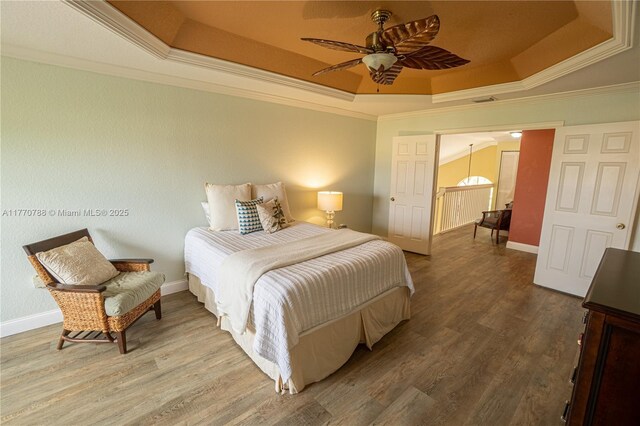 16473 SW 30th St, Miramar, FL 33027 - bedroom featuring a tray ceiling, ornamental molding, wood finished floors, and ceiling fan