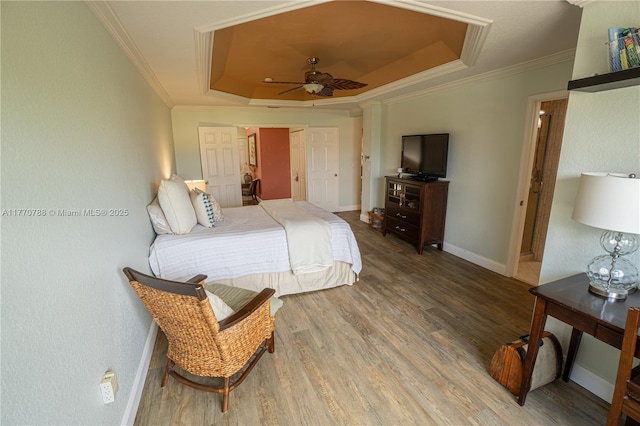 16473 SW 30th St, Miramar, FL 33027 - bedroom featuring a tray ceiling, wood finished floors, and ornamental molding
