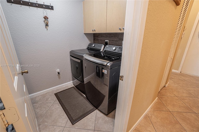 16473 SW 30th St, Miramar, FL 33027 - laundry room with washer and dryer, cabinet space, light tile patterned flooring, and a textured wall