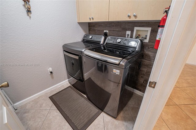 16473 SW 30th St, Miramar, FL 33027 - washroom featuring washing machine and clothes dryer, cabinet space, light tile patterned flooring, and a textured wall