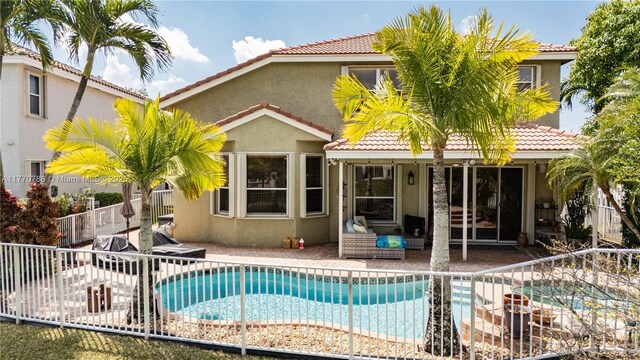 16473 SW 30th St, Miramar, FL 33027 - rear view of house featuring a tiled roof, stucco siding, and a patio area