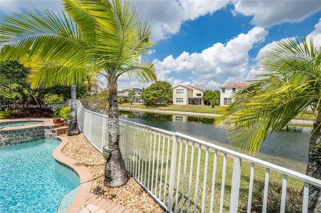 16473 SW 30th St, Miramar, FL 33027 - view of pool with a fenced backyard, a water view, and a pool with connected hot tub