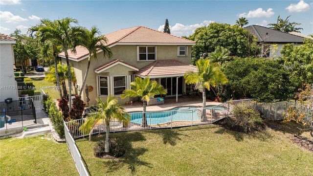 16473 SW 30th St, Miramar, FL 33027 - back of property featuring a fenced backyard, stucco siding, a tiled roof, and a patio