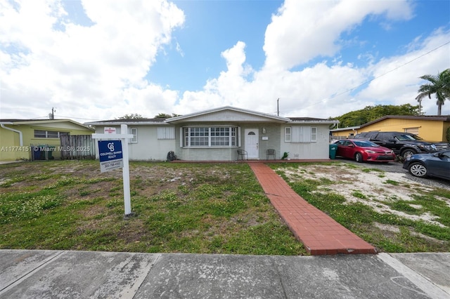 8110 NW 185th Ter, Hialeah, FL 33015 - view of front of house with a front yard, stucco siding, and fence