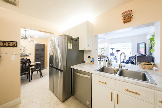8110 NW 185th Ter, Hialeah, FL 33015 - kitchen with appliances with stainless steel finishes, white cabinets, visible vents, decorative backsplash, and a sink