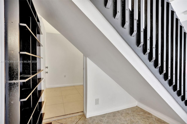 interior space featuring tile patterned flooring and baseboards