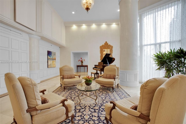 3530 Mystic Pointe Dr Unit 2903, Aventura, FL 33180 - living room with ornate columns, a decorative wall, recessed lighting, wainscoting, and ornamental molding