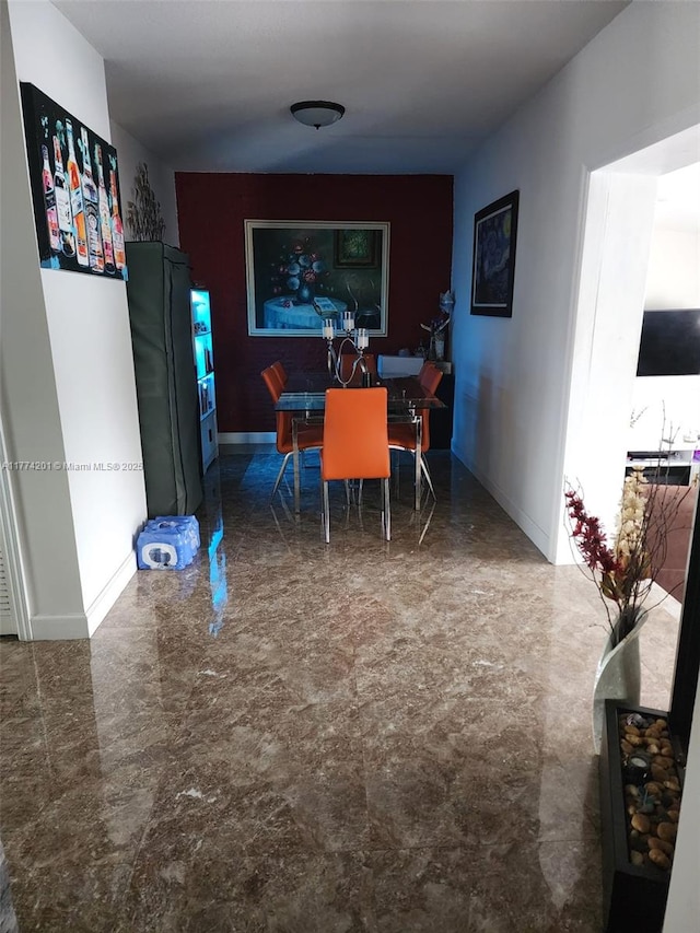 dining space featuring baseboards