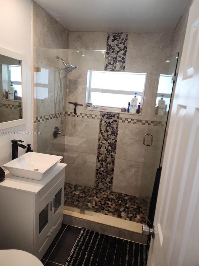 bathroom featuring a shower stall, vanity, and tile patterned flooring