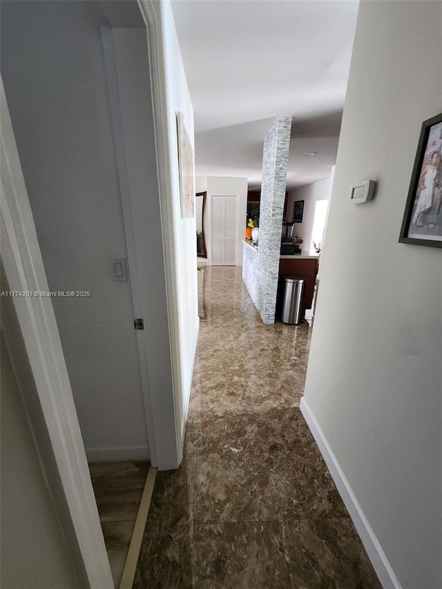corridor featuring baseboards