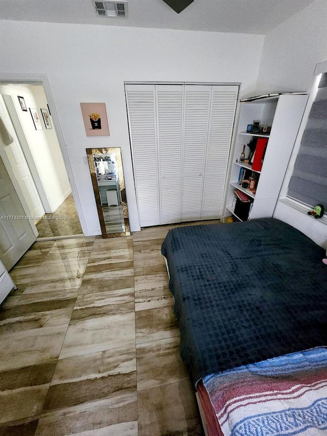 bedroom with a closet and visible vents