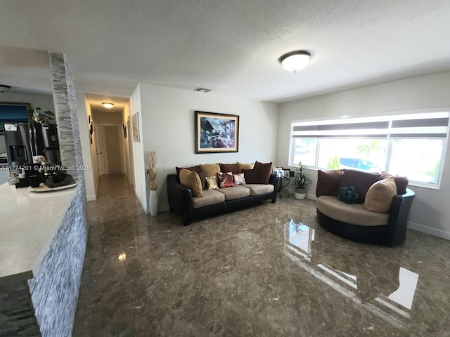 living area featuring baseboards, a textured ceiling, plenty of natural light, and marble finish floor