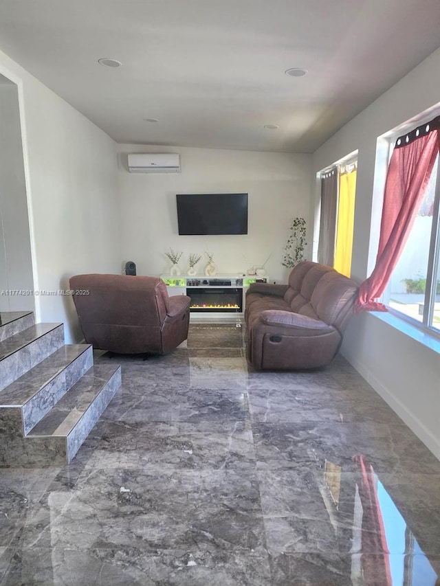 living area with marble finish floor, baseboards, and an AC wall unit