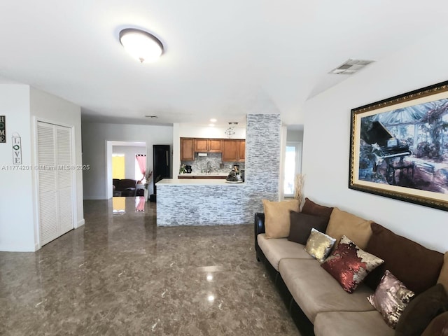 living area featuring marble finish floor and visible vents