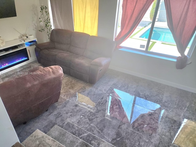 living room featuring marble finish floor and baseboards